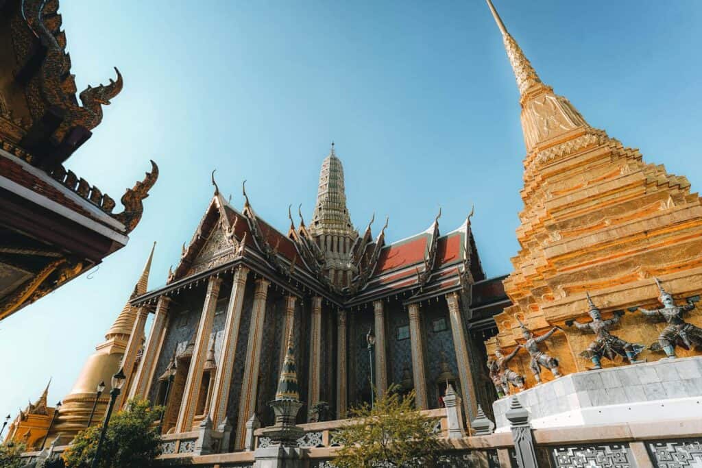 Beautiful capture of Grand Palace temple's intricate architecture and golden pagoda in Bangkok, Thailand.