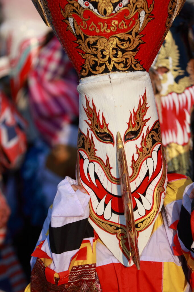 Colourful hand-painted Phi Ta Khon ghost mask with elongated nose at the festival in Dan Sai, Loei Province